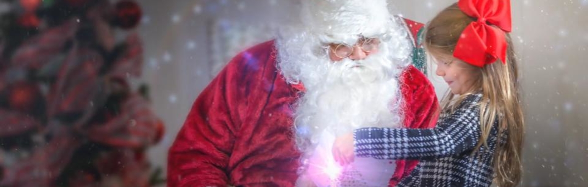 Little girl sharing letter to santa with santa claus