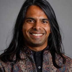 Q Maninvannan wearing a patterned jacket