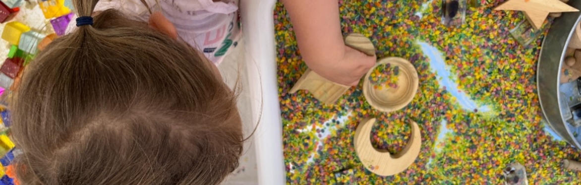 child playing with sand and toys