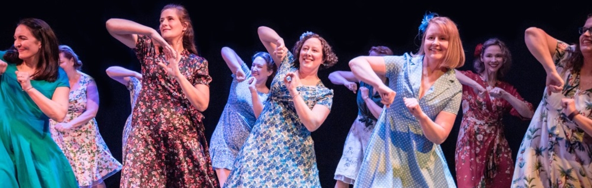 Women smiling and dancing.