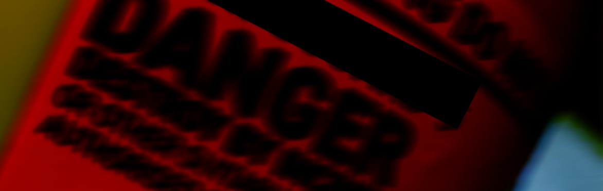 The artwork for single Rheumatological Blues, its a blurred picture of a sharps disposal box and it says danger in black.