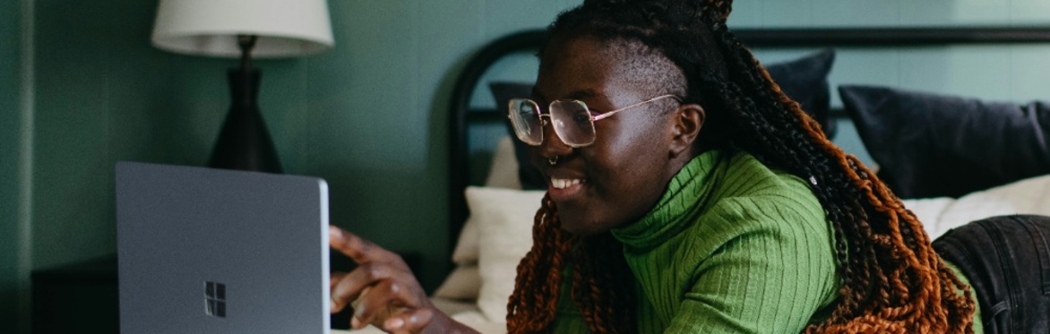 Woman smiling in front of laptop
