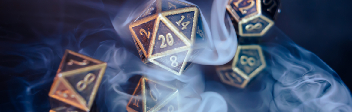 A set of gold metal dice are surrounded by misty smoke.