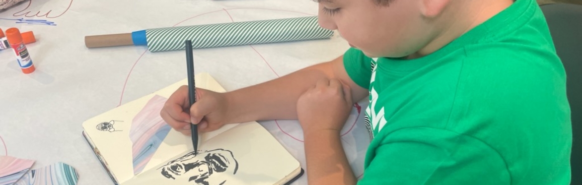 Kid drawing in a sketchbook