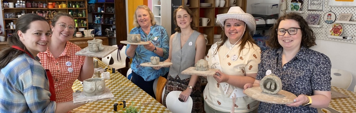 image of handmade pottery class guest rolling clay