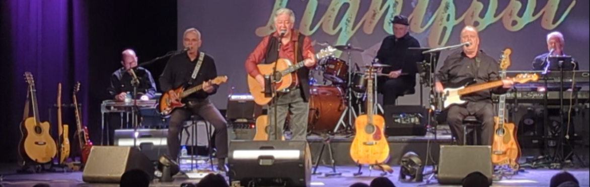 Chris Scott and members of the Whozat Band peforming on stage