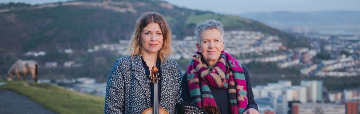 Angharad Jenkins with fiddle next to her mother Delyth Jenkins with harp