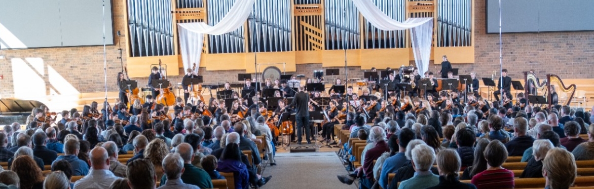 Symphony students stand on stage