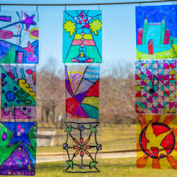Colorful children's artwork in front of a window
