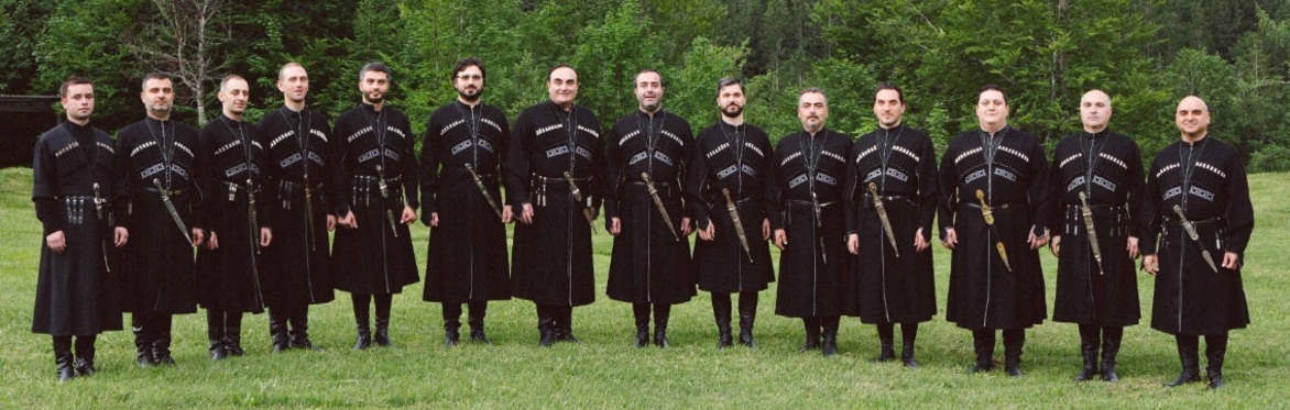 Rustavi in chokhas, standing in a meadow