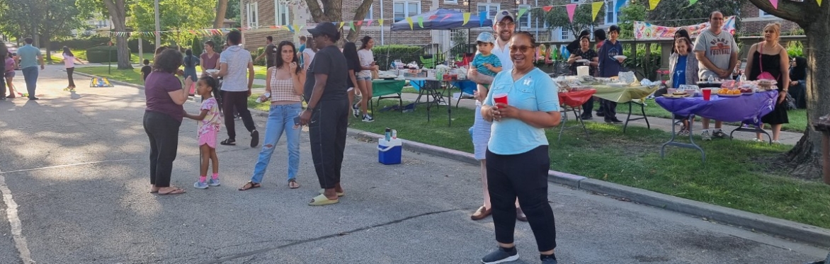 Neighbors gathering together in the street during a block party event.