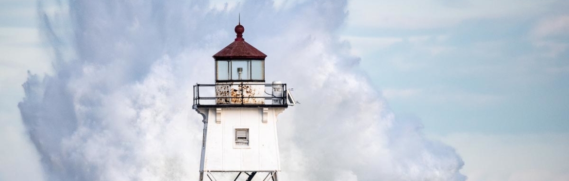 Waves breaking over a lighthouse.