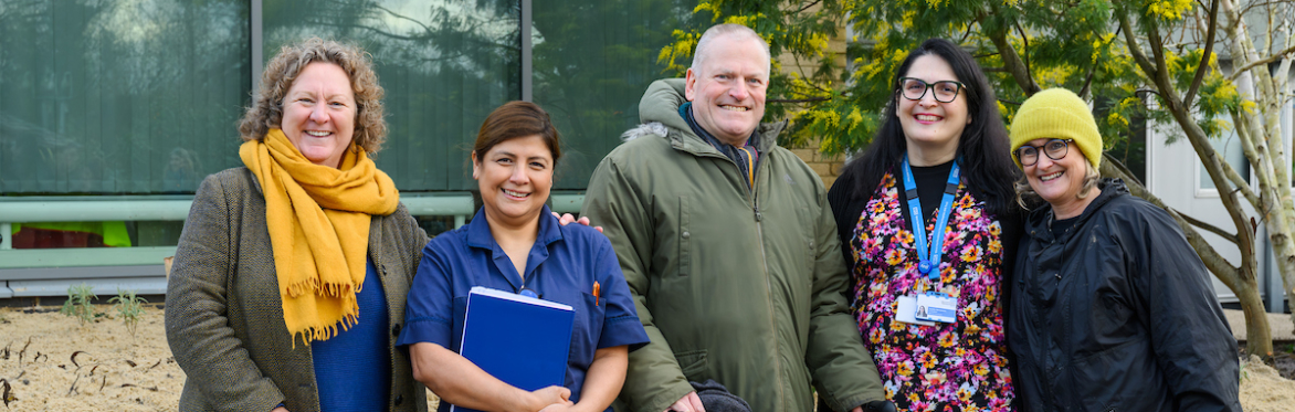 People smiling in a hospital garden