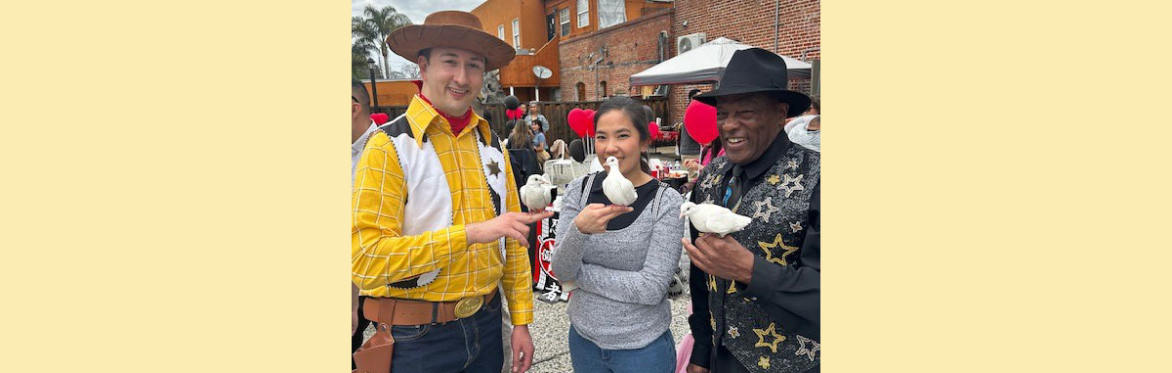 magician and guests holding doves