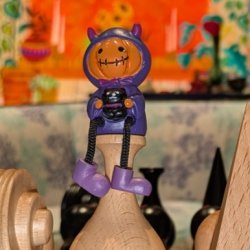 A jack-o-lantern wearing a purple hoodie
