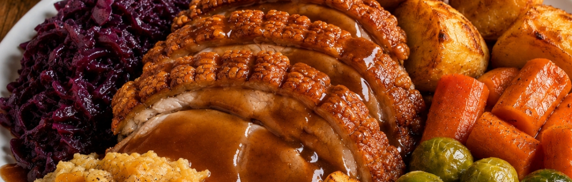 Roast pork with crackling.  Served with Yorkshire puddings, roast potatoes, red cabbage, Brussels sprouts, roast parsnips, carrots, creamed rutabaga and lashings of gravy!!