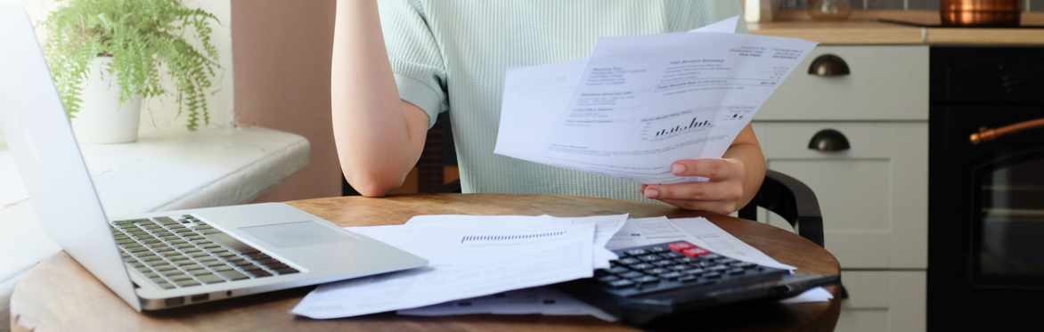 woman working through finances at the kitchen table