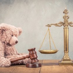 A teddy bear next to a set of scales