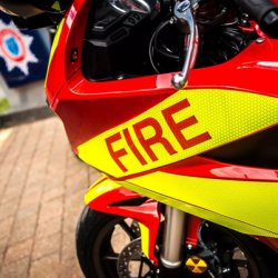 A red Honda VFR with fire written on it outside Cheshire Fire & Rescue Services HQ
