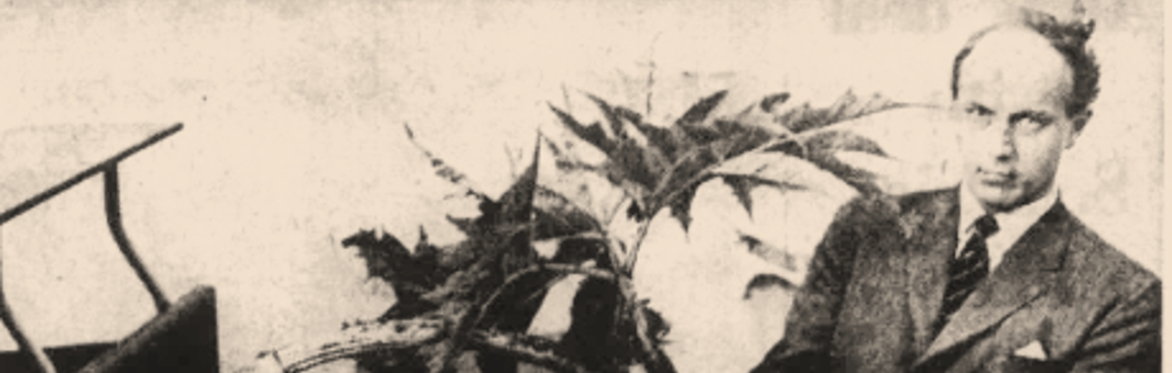 A man in suit holding a piece of Giant Hogweed.