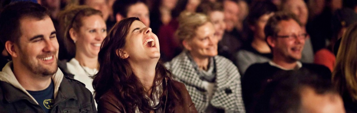 Audience featuring people laughing
