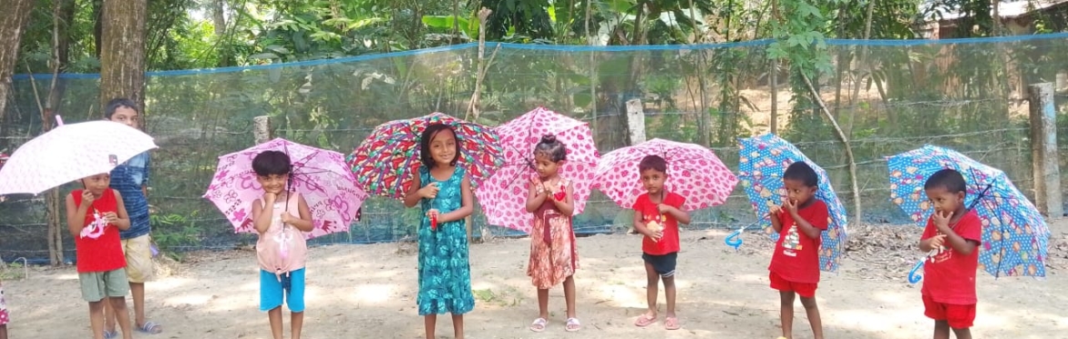 Young children holding umbrellas in the rain
