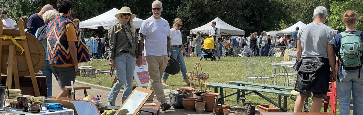 vistors browsing mid century chairs and other furniture outside Beckenham Place Mansion, south east London, at  So Last Century's Vintage Market