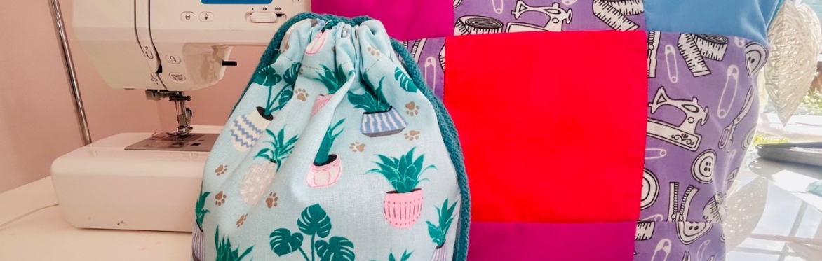 sewing machine with a patchwork cushion next to it.