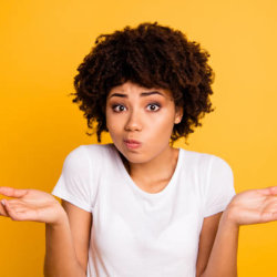 Close up of a woman with a puzzled gesture/shrugging her shoulders