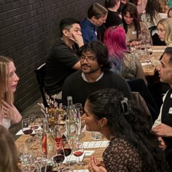 People talking over glasses of wine