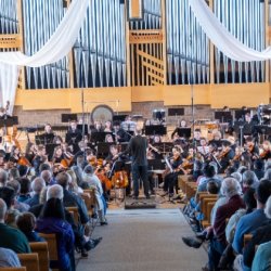 Symphony students stand on stage