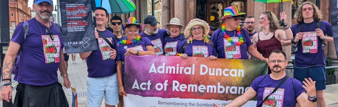 Lovely group of people standing with the Admiral Duncan Memorial Banner
