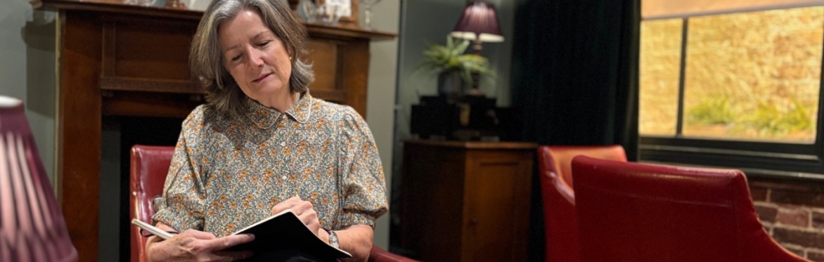 Author Judith Heneghan sat in the Cabinet Rooms Foreign Office writing in a pad that’s resting on her knee