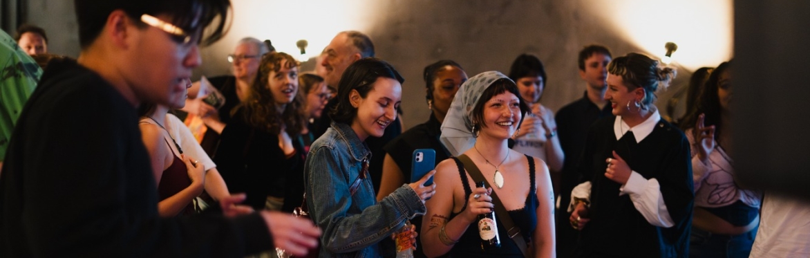 A group of people dancing in a bar space