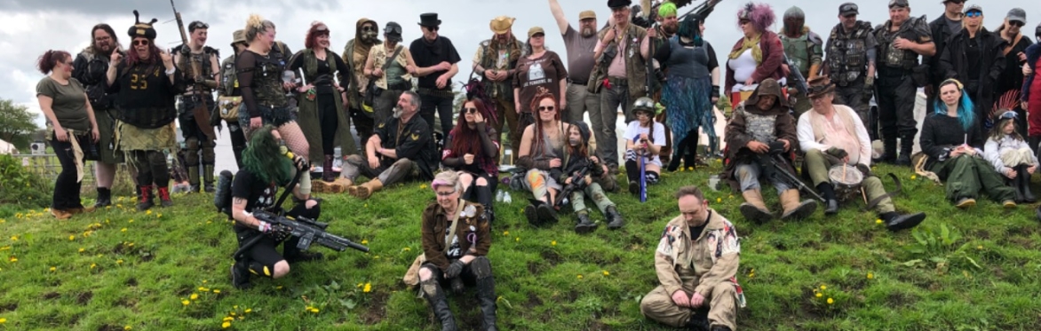 Survivors standing on a grassy bank.