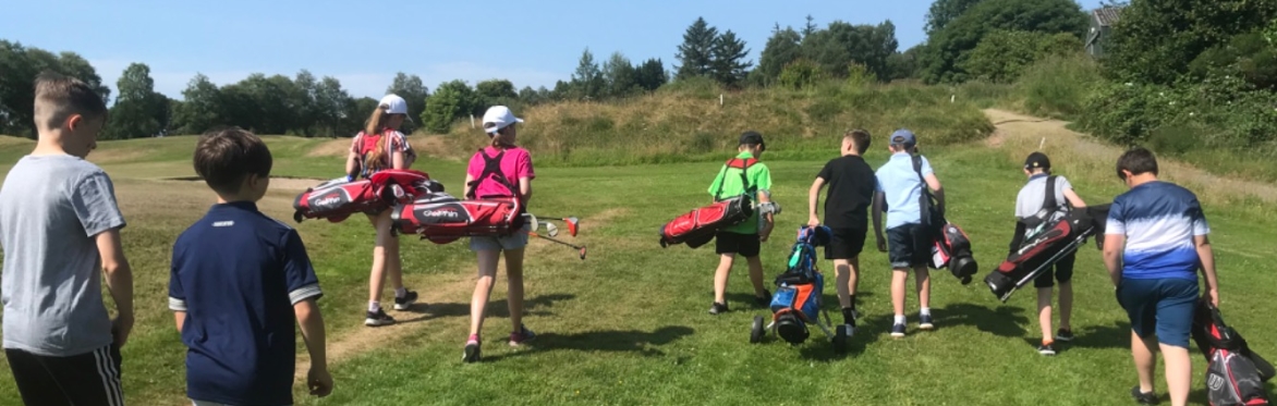 Junior golfers heading out on to the course.