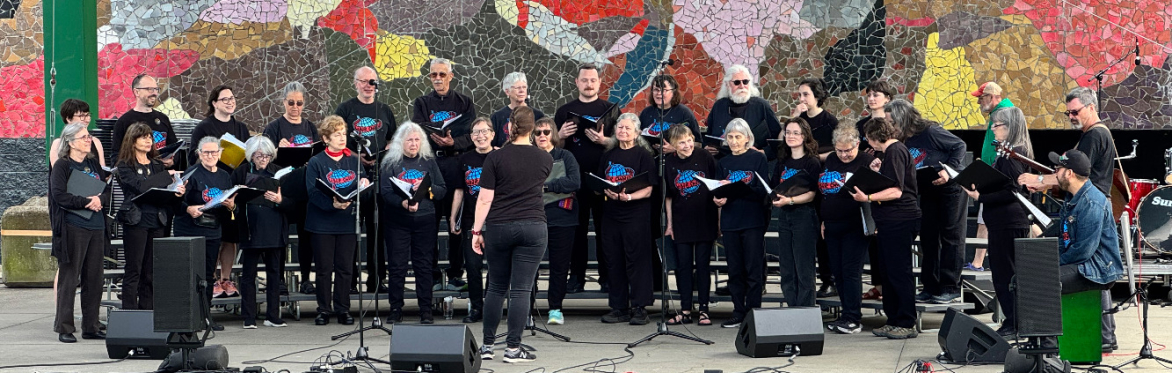 Seattle Labor Chorus perform at the Mural Amphitheater at Folklife 2025.