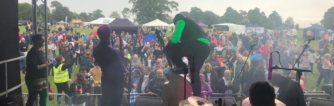 Live band on stage at Festability, with crowd dancing at accessible music festival in Kent.