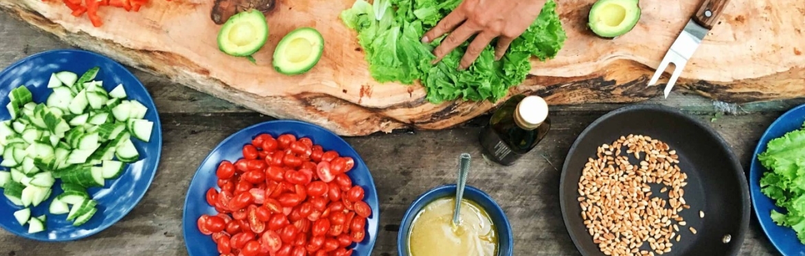 Hands reaching for a board full of fresh ingredients