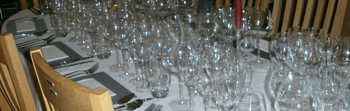 Gareth's table set for a dinner for 10 with many glasses for each person