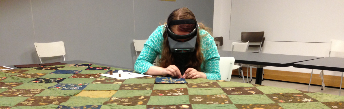 Textile conservator repairing historic quilt