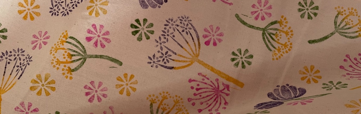 multi coloured 'seed heads' block prints on a cream cotton tea towel