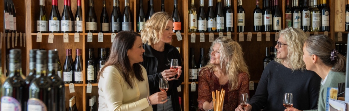 People smiling and drinking wine with each other