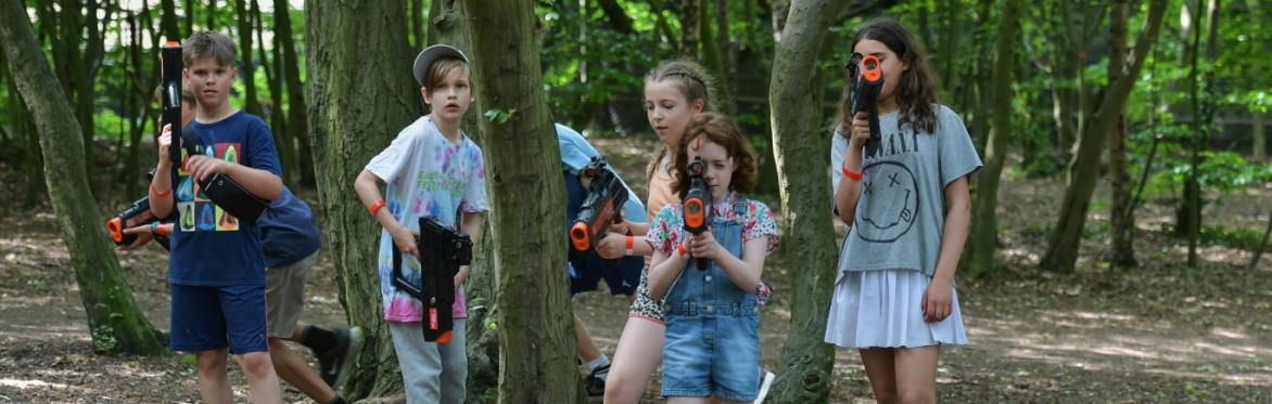 Children playing laser tag in the woods