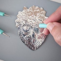 image shows a copper bookmark with hand stamped design that reads 'eat sleep read repeat'