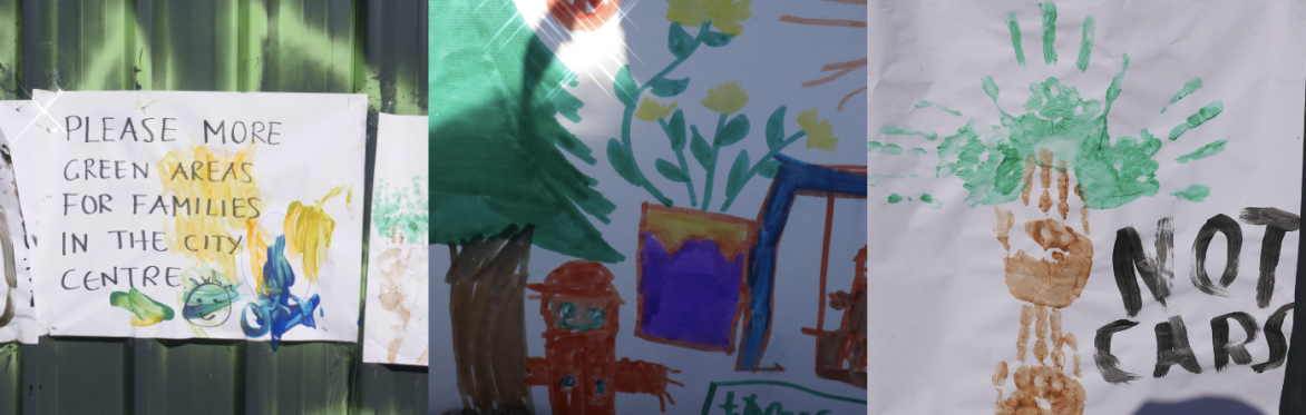Trees Not Cars placards showing flowers, handprints and lettering saying "Please more green areas for families in the city centre"