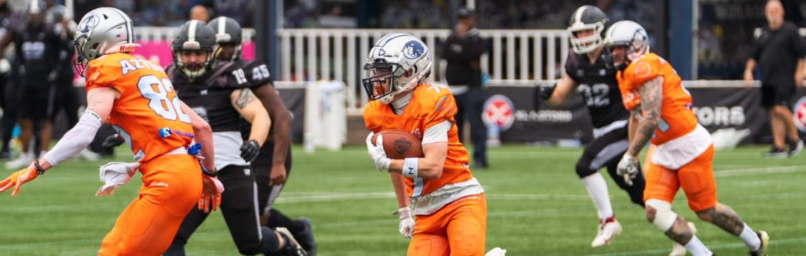 An American football player returns a kick-off at the Britbowl.