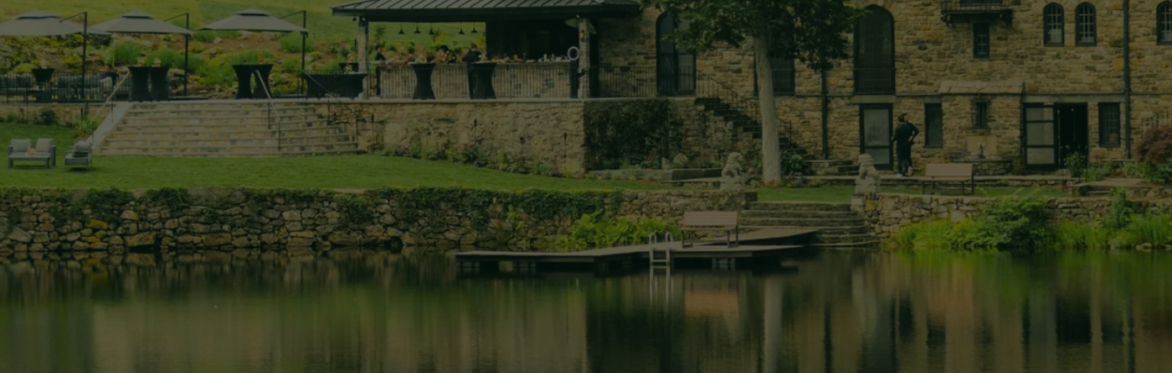 Faded image of lake shore and a stone building
