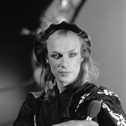 Brian Eno in makeup, looking glam even with thinning hair.