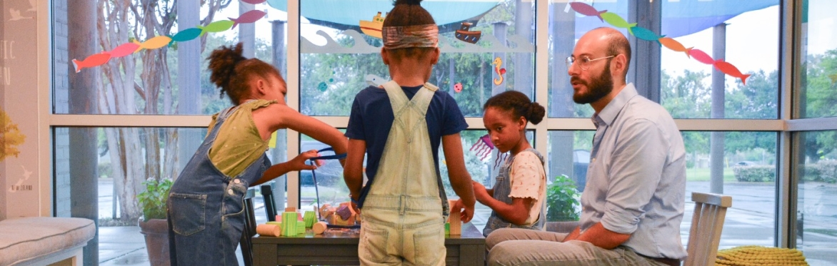 ACGC therapist with young clients in playroom